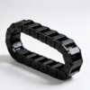 Black cable drag chain links formed into a loop, each link with a round pivot boss and an open window for cables