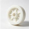 White plastic flanged hub wheel body with central bore and radial ribs, custom injection molded part for conveyor assemblies