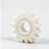 White plastic spur gear with spur tooth profile and central bore, custom injection molded transmission part