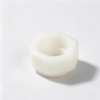 White plastic hex nut with hexagonal body, threaded central bore and a wider molded base, custom injection molded part