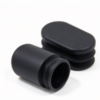 Black oval tube plug in matte black, a grooved profile plug with an oval face on a white background