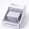 Extruded aluminum enclosure packed in its printed carton, with the cut body and the end plates in view