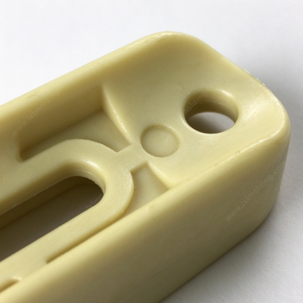 287 (1) Nylon slide block end hole close up, with the counterbore and the molded locating dimple in view