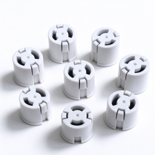 Custom molded push-in snap bushing in white, several bushings set out in a ring on a white bench