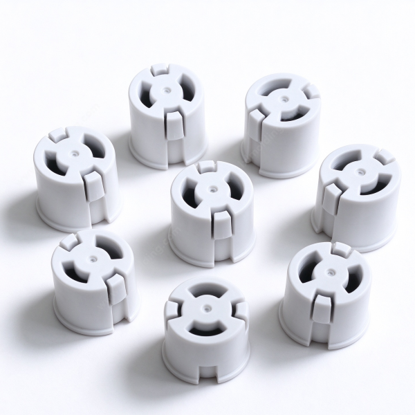 309 Custom molded push-in snap bushing in white, several bushings set out in a ring on a white bench