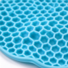 Silicone honeycomb mat in light blue, the hexagon cells and walls in close view on a bench