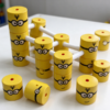 Printed plastic toy blocks in yellow joined by white rods through the bores into a built frame