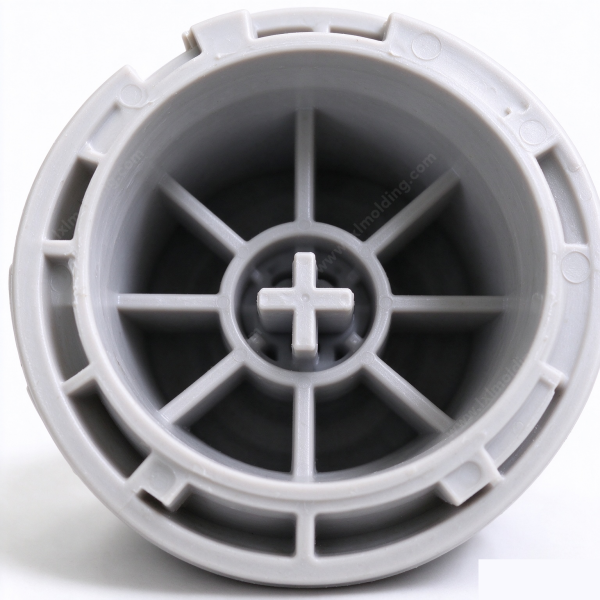 Winding reel hub close up, the eight spokes, the cross shaped center boss and the ring of holes in the outer rim