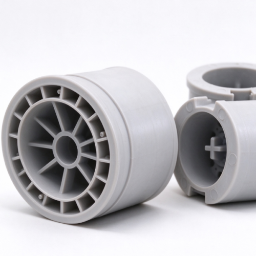 Winding reel hub in gray, three molded hubs standing side by side with their spoked faces and stepped walls