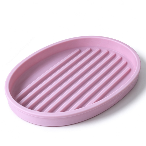 321 Silicone drain pad in pink, the oval base with straight ribs across it and a raised rim all round