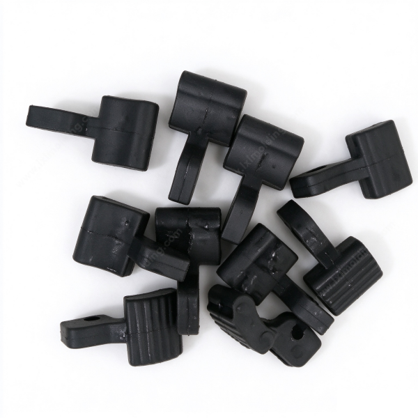 337 Rubber buffer buckle in black, a heap of molded pads and strap loops with the ribbed face and the through hole in view