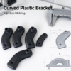 Curved plastic bracket with gray dimension views and a caliper, marked Curved Plastic Bracket and Injection Molding